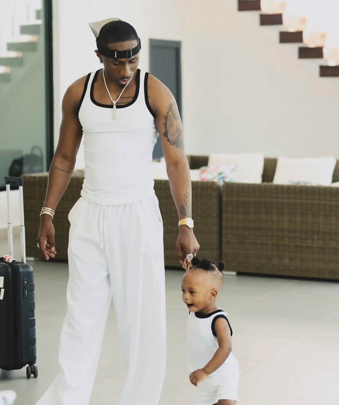 Juma Jux and his son Rakeem in matching white outfits