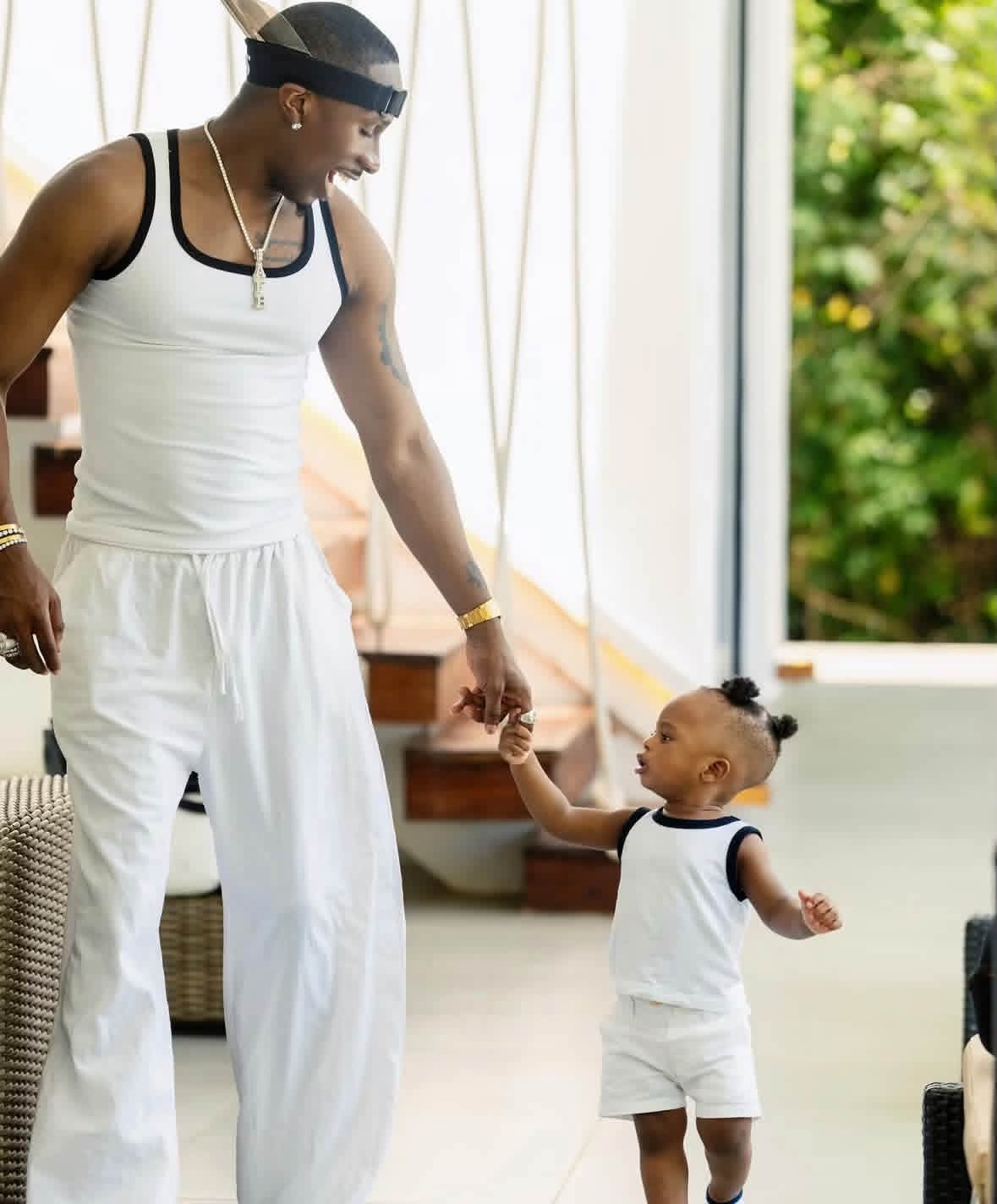 Juma Jux and his son Rakeem in matching white outfits