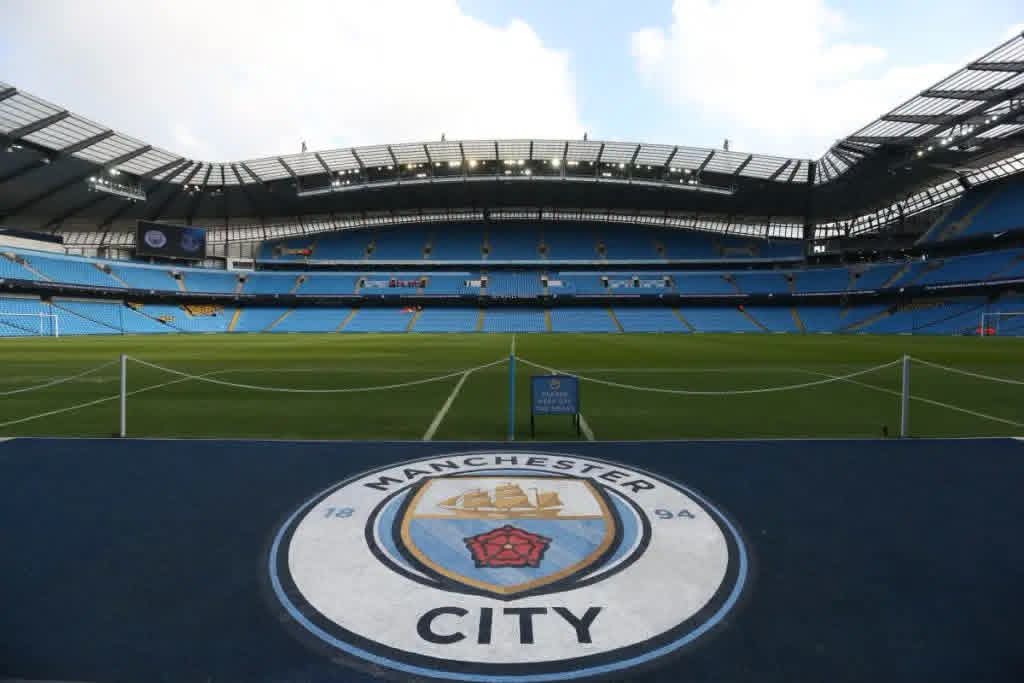 Manchester City crest on the pitch at the Etihad Stadium