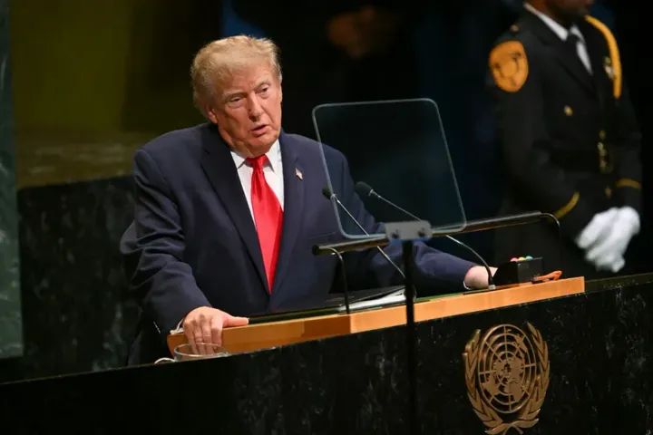 Donald Trump speaking at a podium